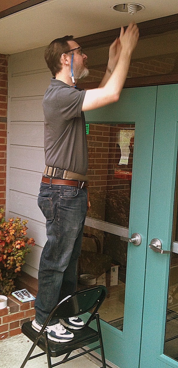 Steve helps us go green, putting in a CFL bulb