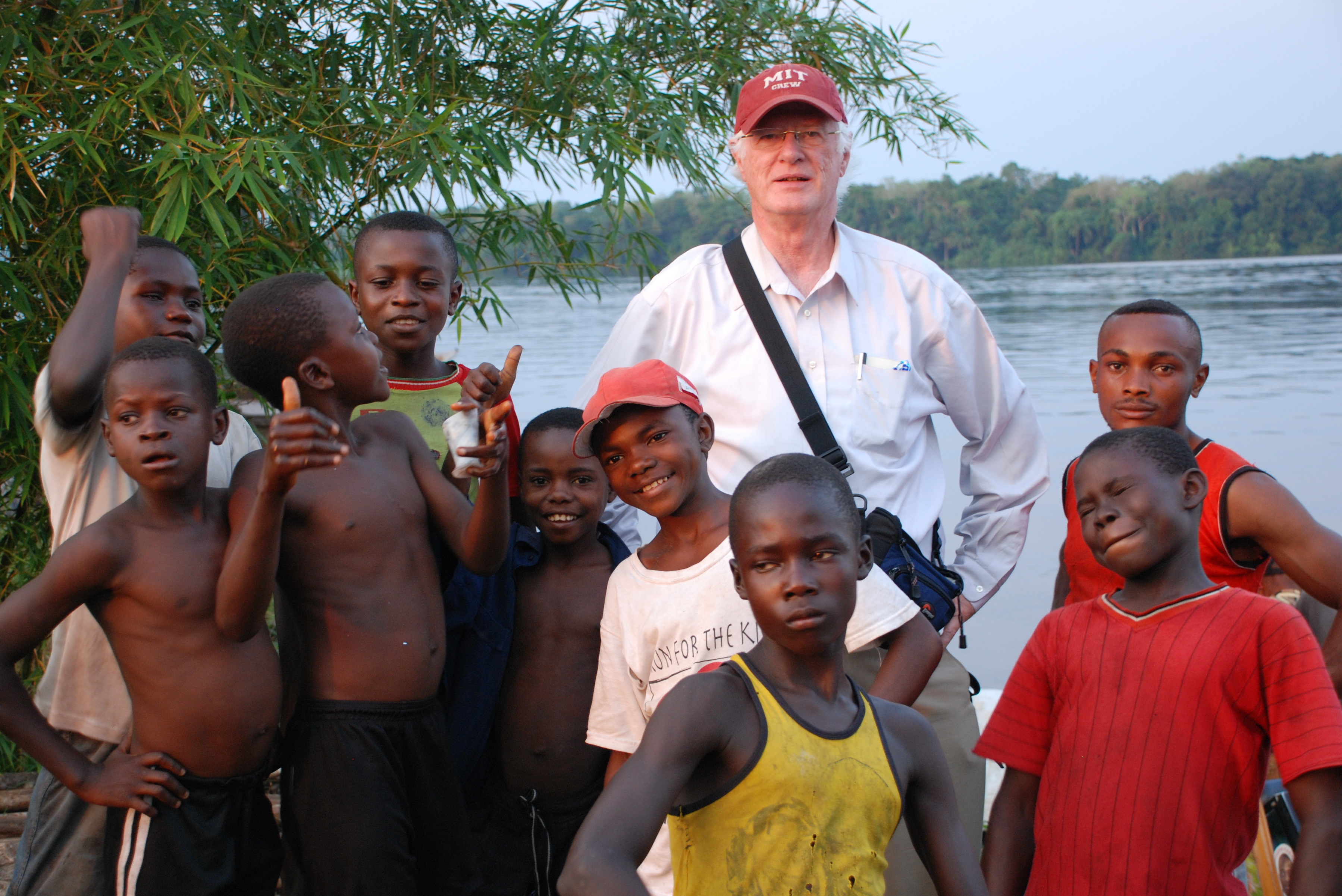 photo of Brookmeade member Raymon White with children on trip for Project C.U.R.E.