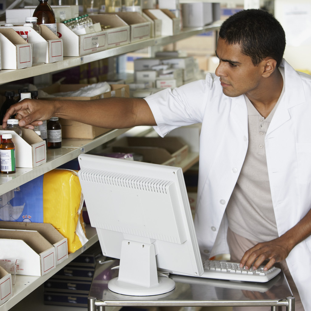 Photo of pharmacist using a computer.